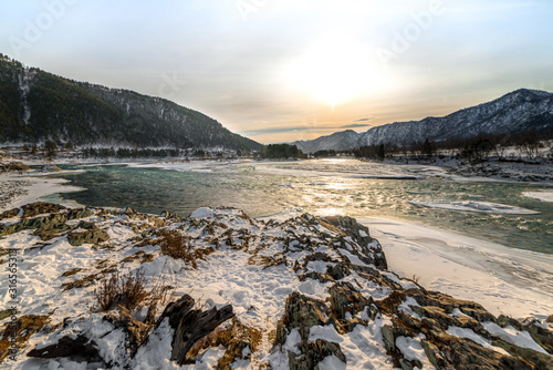 Landscape with snow-capped mountains and mountain river