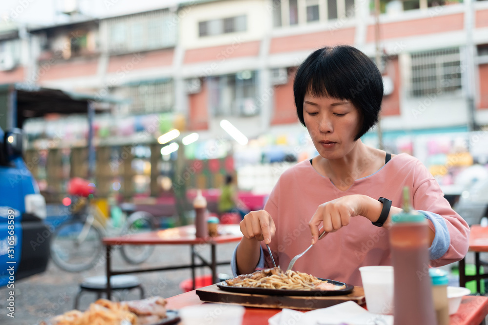 woman eat Taiwanese night market steak woman eat Taiwanese night market steak