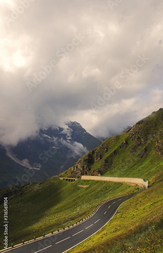 Foggy mountains and road view. Alps  travel destination.