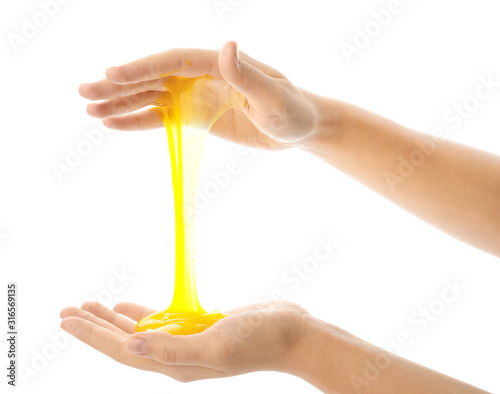 Woman playing with yellow slime isolated on white, closeup. Antistress toy