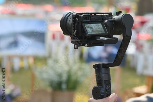 The photographer Video camera operator on stabilizers working with his equipment to pay close attention to take a photo. photo