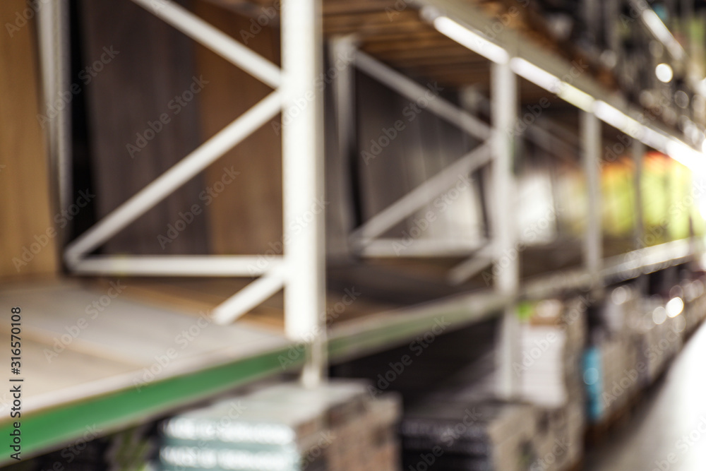 Blurred view of storage stands with different building materials in wholesale warehouse Blurred view of storage stands with different building materials in wholesale warehouse