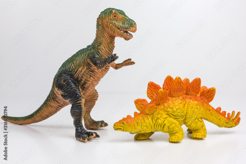 Naklejka premium plastic toy figures of tyrannosaurus rex and stegosaur