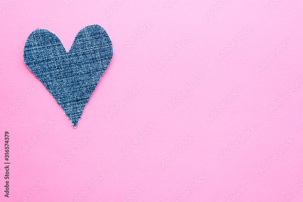 Denim heart isolated on pink background. Mockup for greeting card. Copy space.