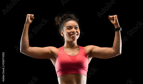 Happy fitness model raising her hands up, celebrating success © Prostock-studio