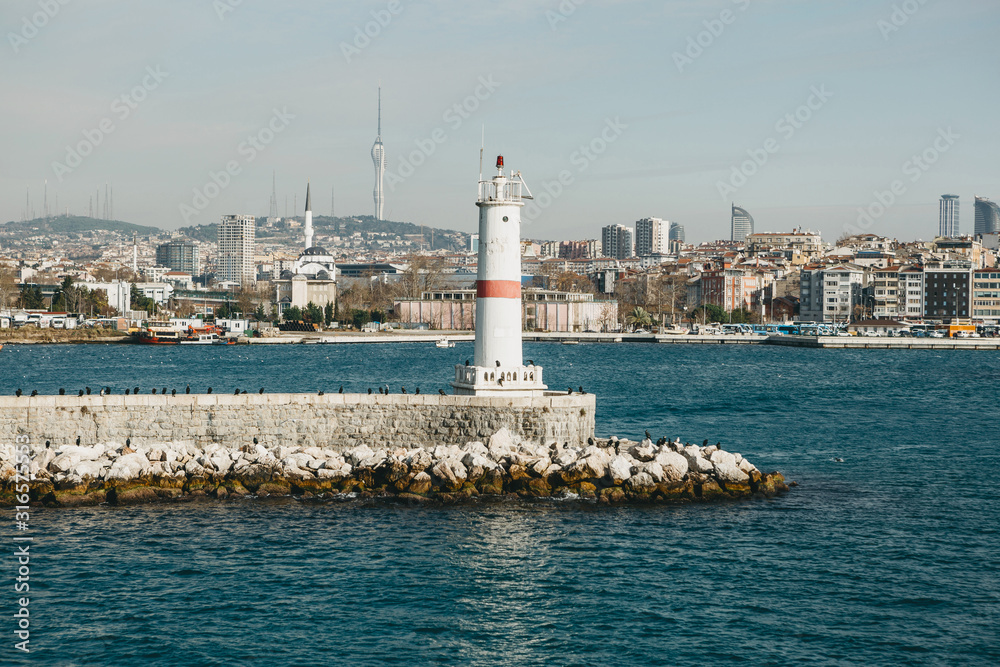 Beautiful view of the lighthouse against the background of urban architecture in Istanbul in Turkey