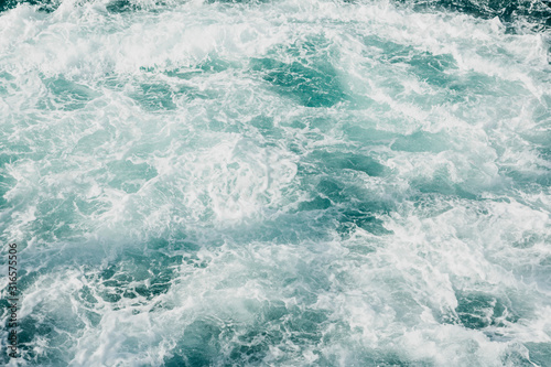 Sea foam background. Clear blue sea water with foam