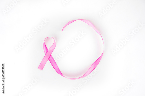 Flat layout of pink ribbon curling and coiling