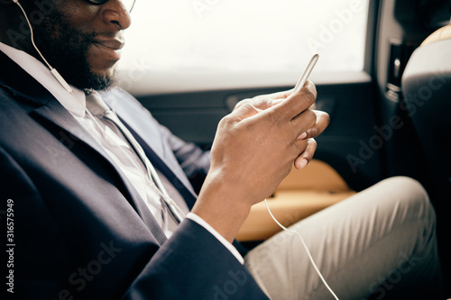 Man in the car using his ipod shuffle.