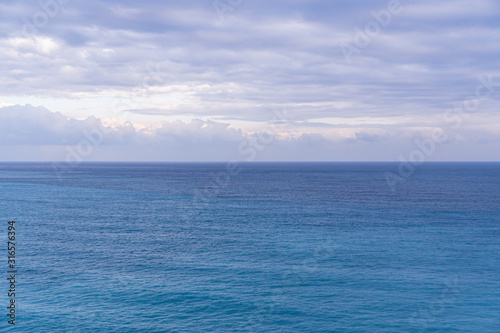 Seascape with sea horizon and almost clear deep blue sky, Background, copy space