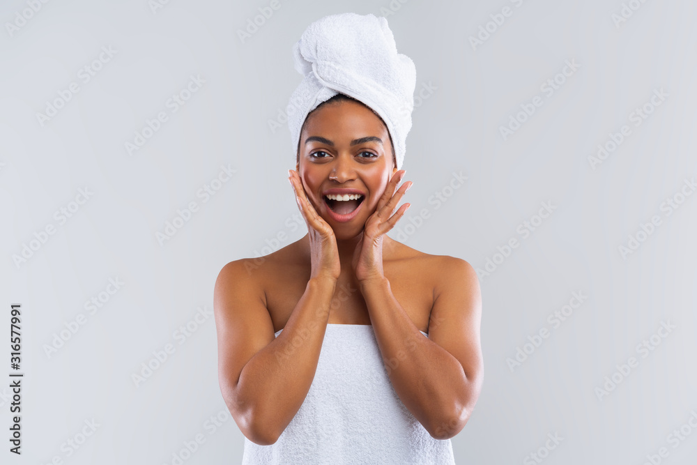 Excited black lady wrapped in towel expressing amazement Excited black lady wrapped in towel expressing amazement