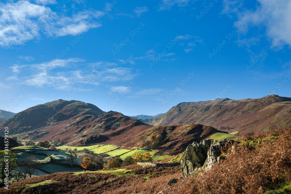 Majestic Autumn Fall landscape image of Sleet Fell and Howstead Brow in Lake District with beautiful early morning light in valleys and on hills Majestic Autumn Fall landscape image of Sleet Fell and Howstead Brow in Lake District with beautiful early morning light in valleys and on hills