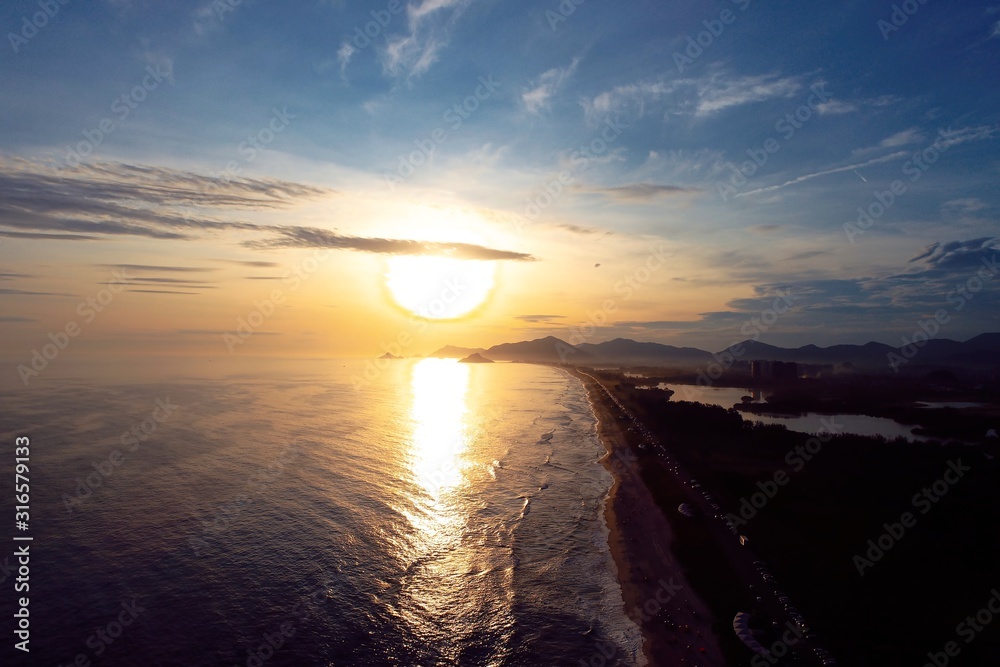Aerial view of sunset on Barra da Tijuca's Beach,  Rio de Janeiro city in the sunny day, Brazil. Great landscape. Vacation travel. Travel destination. Tropical travel. 