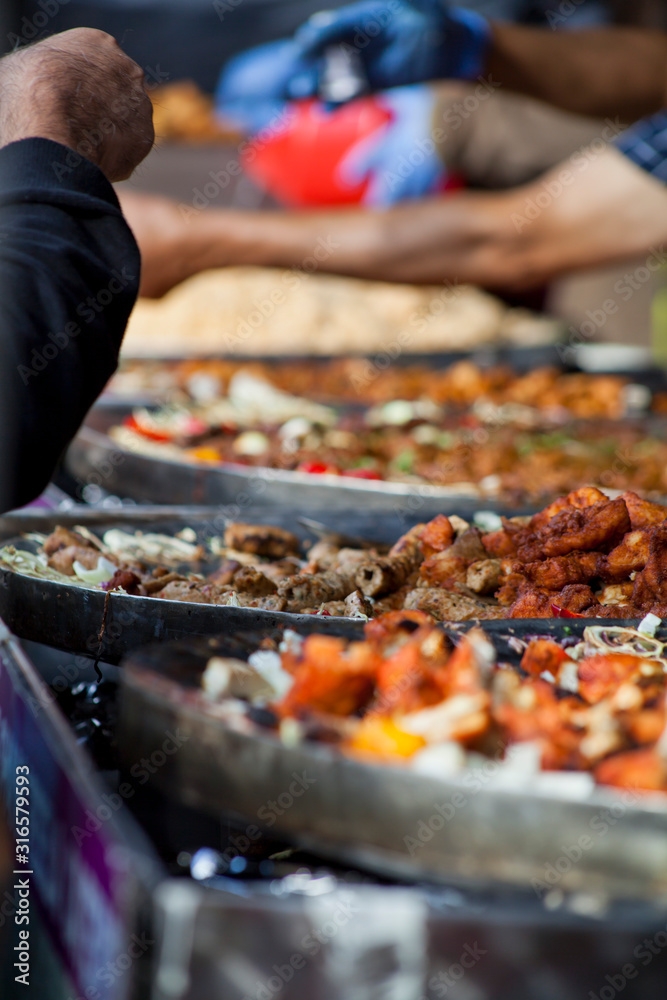 Pakistani cuisine Street food - rice, curry, lamb skewers  and bread selection.