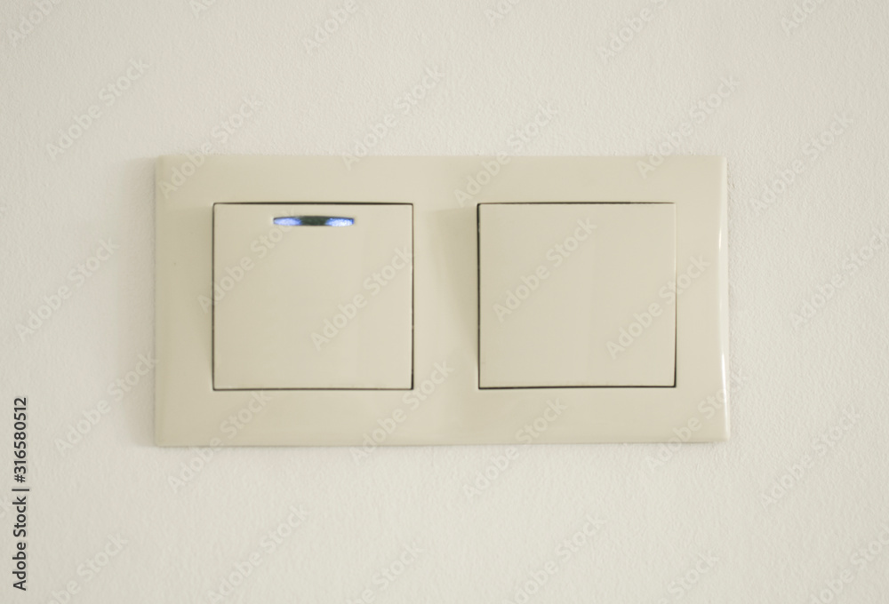 Double switch with blue diod on white wall Double switch with blue diod on white wall