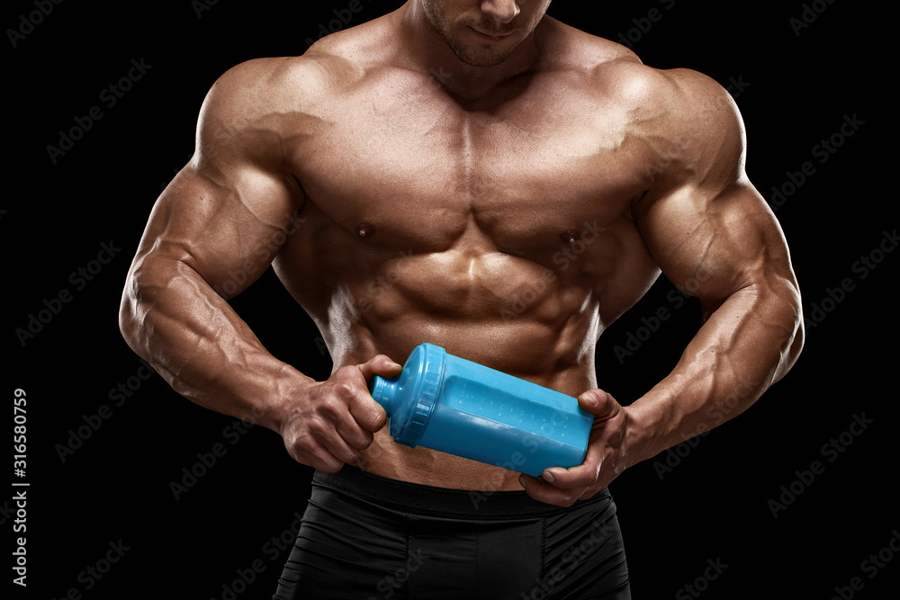 Naklejka premium Muscular man with shaker isolated on black. Strong male naked torso abs