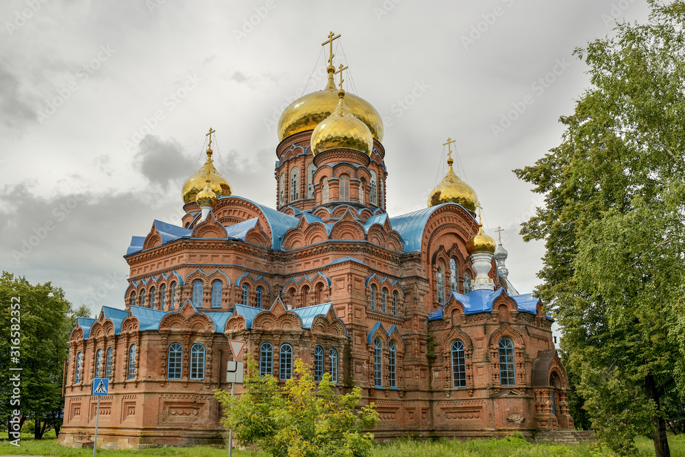 Ancient orthodox church of red brick with golden domes.