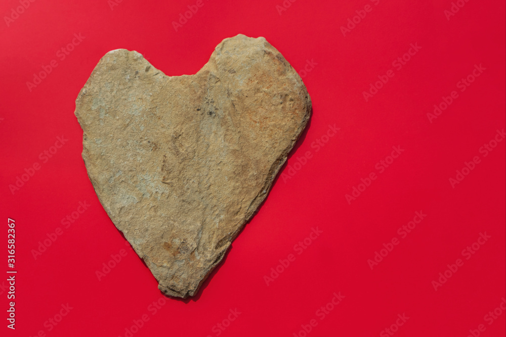 Natural rough heart shaped stone on red background. Flat lay, copy space.  Concept of fake love. Stock Photo | Adobe Stock