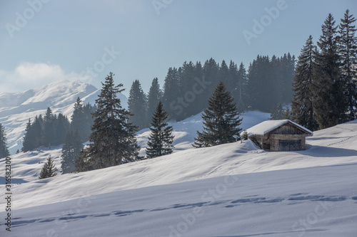 Mountain huts in a snowy landscape in the swiss Alps, Switzerland, Europe © Tim on Tour