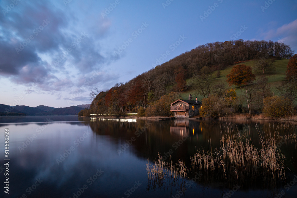 Fototapeta premium Epic vibrant sunrise Autumn Fall landscape image of Ullswater in Lake District with golden sunlight