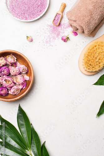 Dry rose flowers and pink salt. Wellness and body care flat lay concept