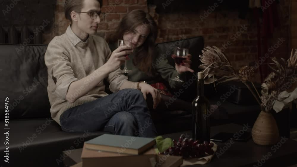 Couple celebrating event with red wine, shallow depth of field, slow motion Couple celebrating event with red wine, shallow depth of field, slow motion