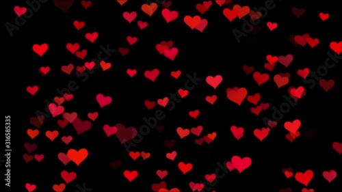 Seamless loop soft focused small red hearts over black background - valentine's day or love festival decoration background 