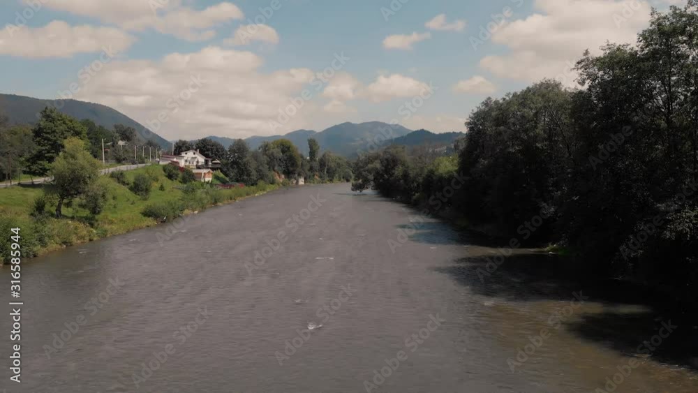 Top view of river flowing at mountains countryside. Countryside with river view in Carpathians, Ukraine. Top view of river flowing at mountains countryside. Countryside with river view in Carpathians, Ukraine.