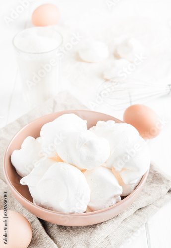 Baked meringue with ingredients on white background