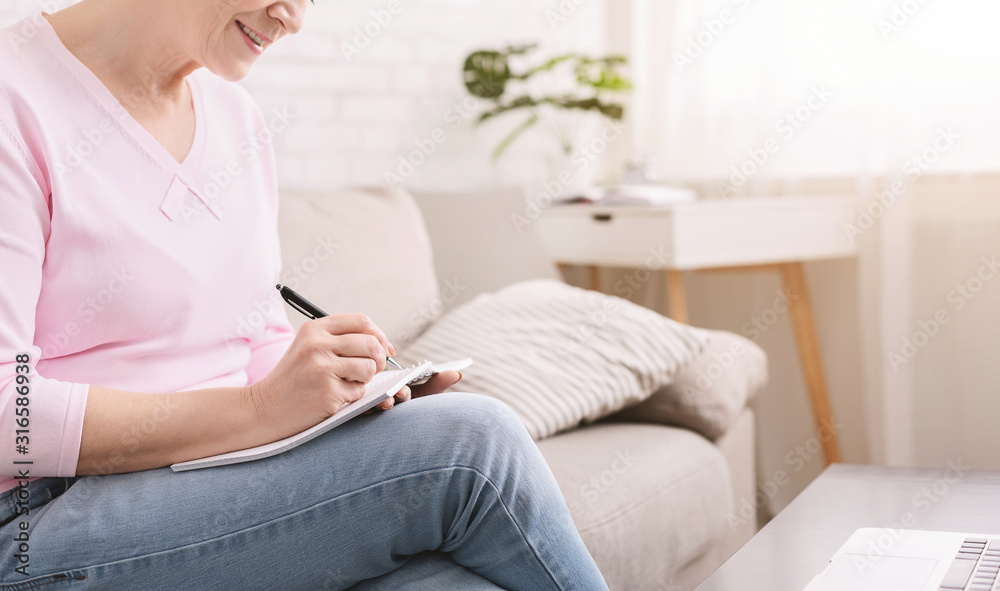 Retired lady noting thoughts at home, panorama Retired lady noting thoughts at home, panorama