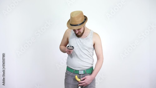 Guy looks at penis in a magnifying glass. The small size, men's problem.