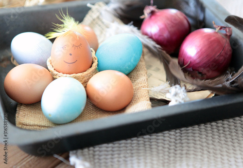 Colorful Easter eggs with smiling emoticon for handpaintings at home. brown eggs face arranged together on the paper background, Selective focus at the eeg. Many colorful organic chicen fresh eggs photo