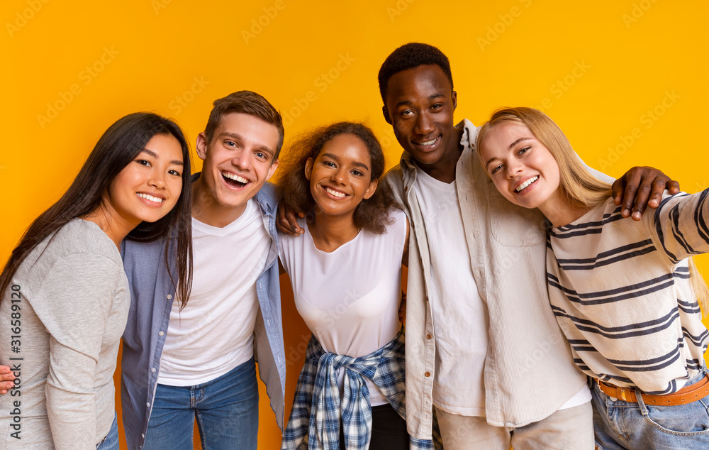 Friendly international students taking selfie over yellow background - obrazy, fototapety, plakaty 