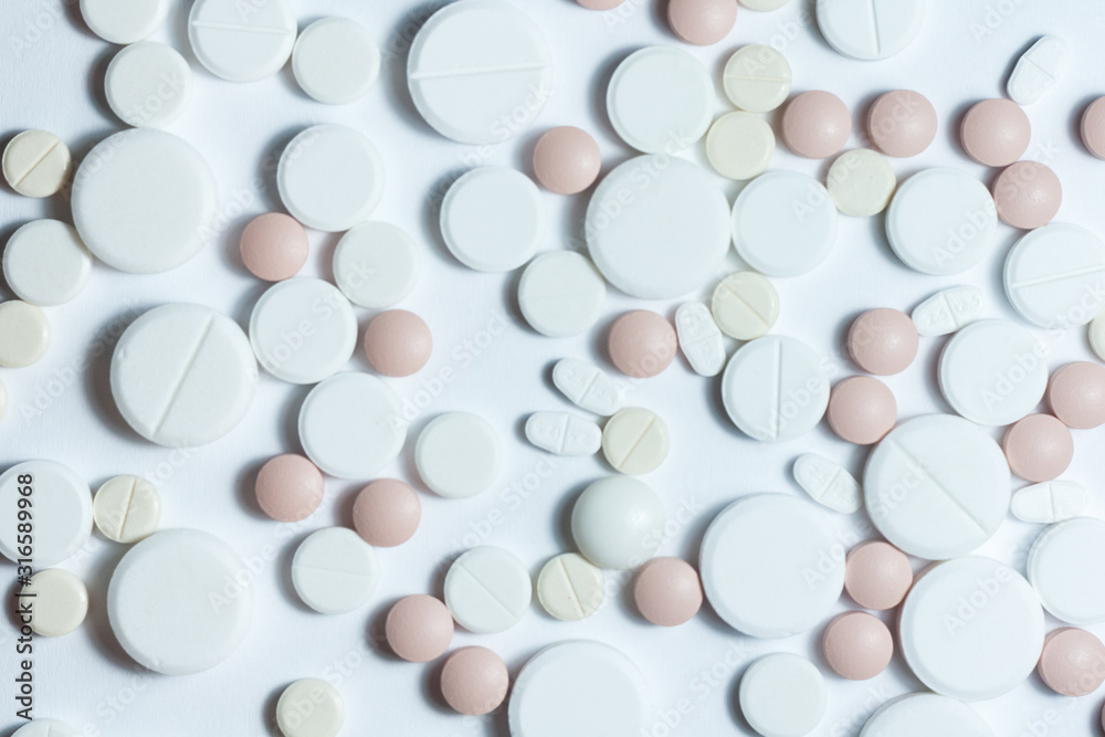 Heap of pills, pharmaceutical medicine tablets and capsules on white background. Drug prescription for treatment medication health care concept, top view with copy space. Heap of pills, pharmaceutical medicine tablets and capsules on white background. Drug prescription for treatment medication health care concept, top view with copy space.