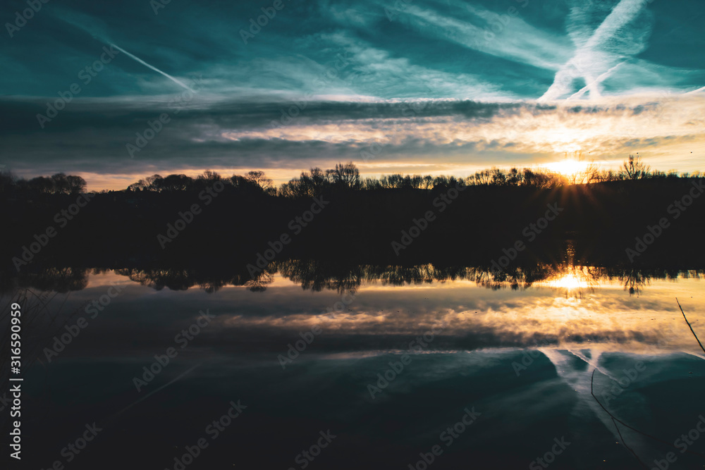 Horizon is reflected in the river at sunrise
