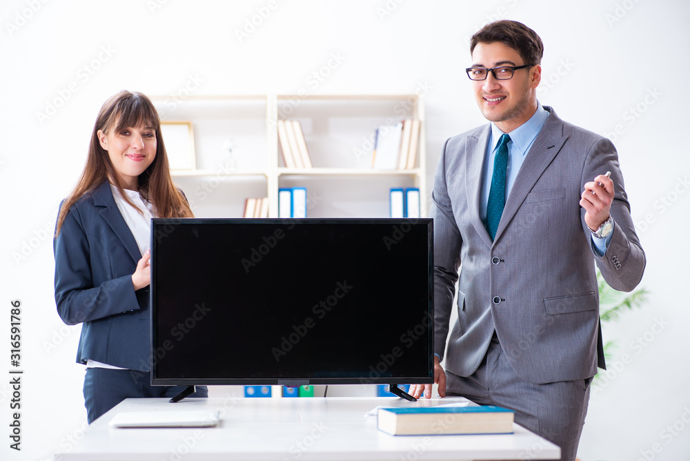 Young employee making presentation to his female boss Young employee making presentation to his female boss