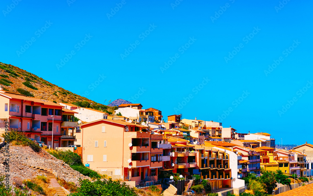 Cityscape with Buggerru city with cottage house architecture at the Mediterranean Sea in South Sardinia in Italy. Sardinian Italian small town in Sardegna.