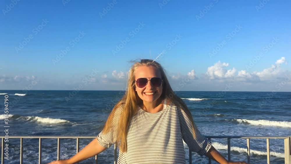 Slow motion beautiful girl looking to camera and smiles. Slow motion beautiful girl looking to camera and smiles.