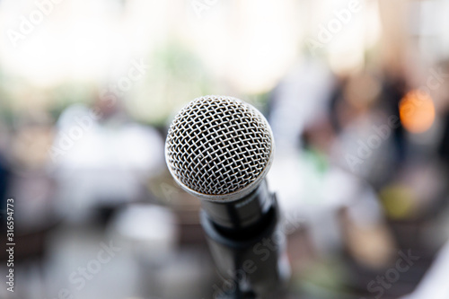 Microphone on blurred of speech in seminar room or speaking conference