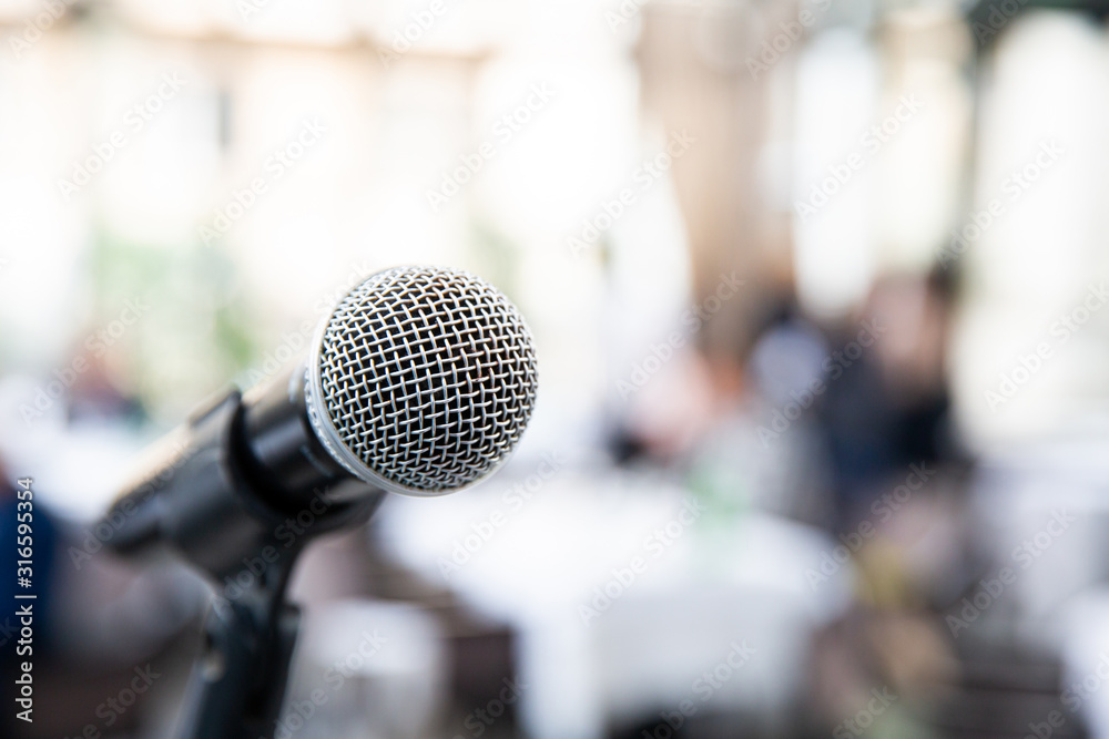 Microphone on blurred of speech in seminar room or speaking conference Microphone on blurred of speech in seminar room or speaking conference