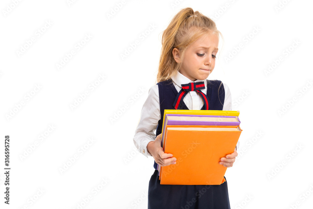 Young schoolgirl with blonde hair holds a lot of books isolated on white background Young schoolgirl with blonde hair holds a lot of books isolated on white background