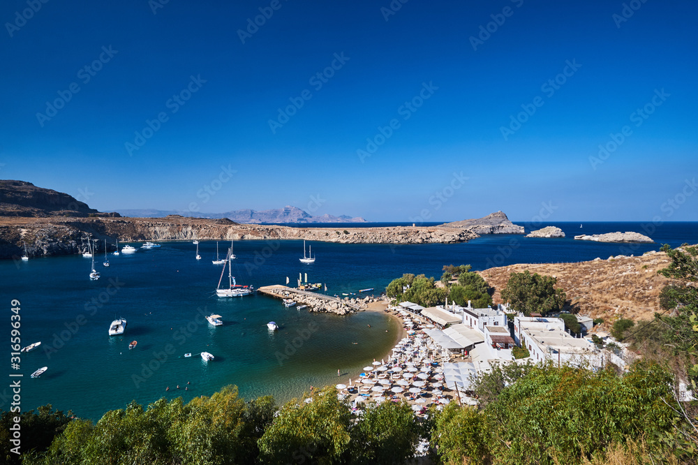 Yachts in the port of Lindos bay on the island of Rhodes. Yachts in the port of Lindos bay on the island of Rhodes.