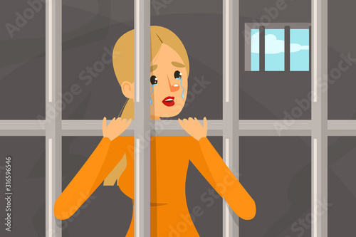 Sad woman standing in prison. Person in orange clothing