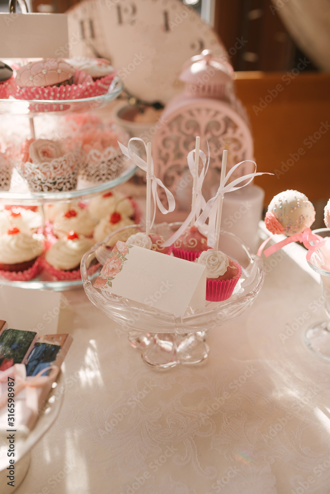 Candy bar at a wedding or birthday party in pink and white