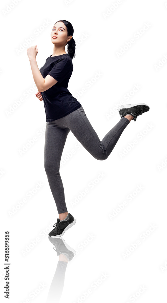Full length portrait of fitness woman in sportswear jumping.