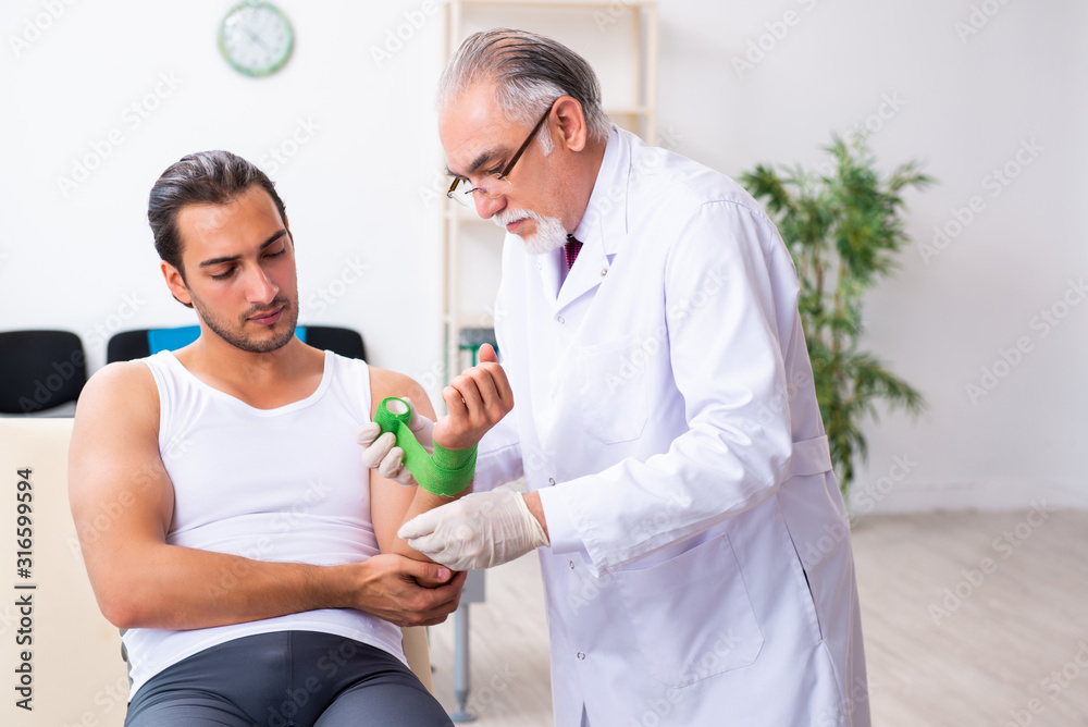 Fototapeta premium Young male patient visiting experienced doctor