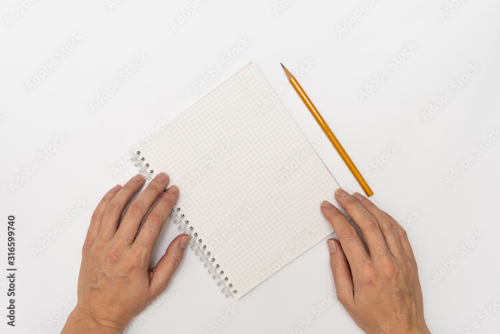 Woman hands holding a notebook and a yellow pencil ready to write, close up top view copy space Woman hands holding a notebook and a yellow pencil ready to write, close up top view copy space