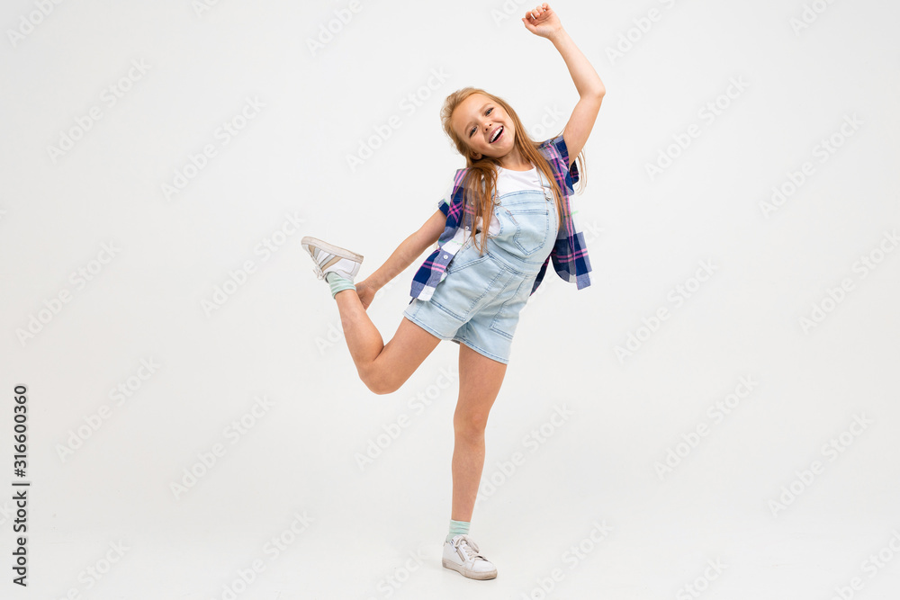 Cheerful teenager girl in stylish clothes dances and enjoy of her life Cheerful teenager girl in stylish clothes dances and enjoy of her life