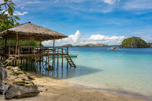 Fototapeta Naklejka Na Ścianę i Meble -  Wood terrace on sandy beach. Tropical beach in El Nido Palawan Philippines