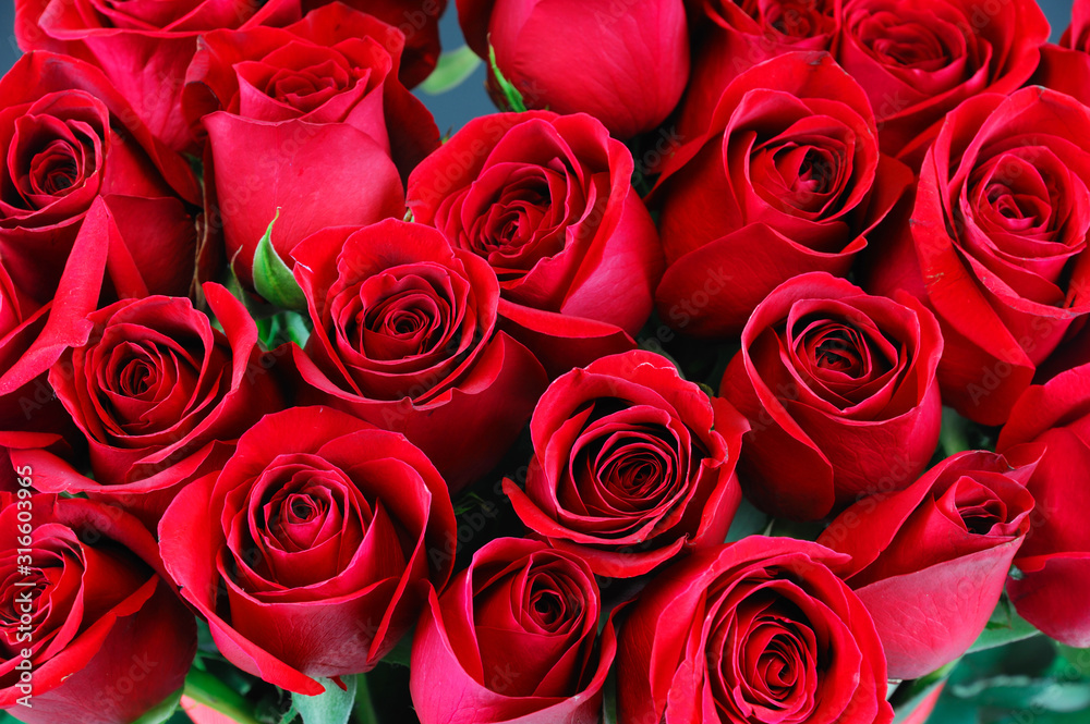 fresh red roses in a bouquet as background - obrazy, fototapety, plakaty 